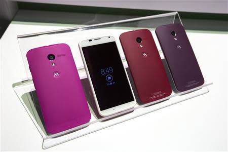 Different colored examples of Motorola's new Moto X phones rest on a table at a launch event in New York, in this August 1, 2013 file photo. REUTERS/Lucas Jackson/Files