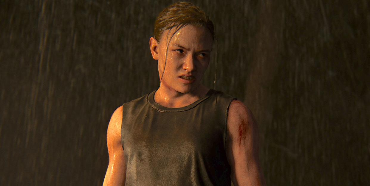 abby stands in the rain looking angry and holding a hammer in the last of us part ii