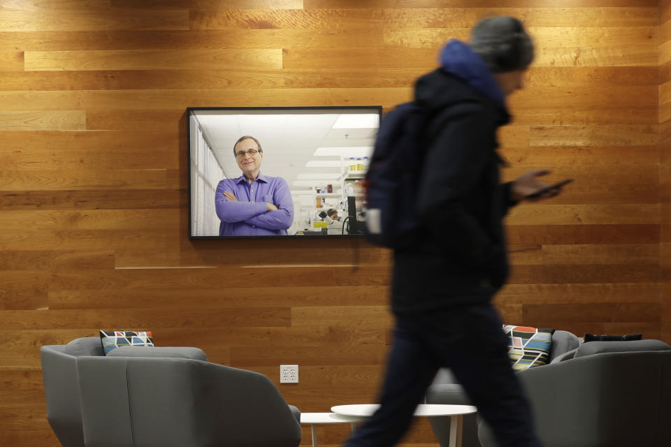 In this Jan. 14, 2020 photo, a photo of founder Paul G. Allen is displayed in a sitting area of the Allen Institute in Seattle. Researchers at the facility stayed late into the evening to study a piece of live brain tissue that was donated by Genette Hofmann as she underwent brain surgery at Harborview Medical Center for epileptic seizures that had disrupted her life for decades. (AP Photo/Ted S. Warren)