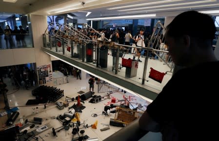 Anti-government protesters pile up projectiles to block police from entering New Town Plaza at Sha Tin