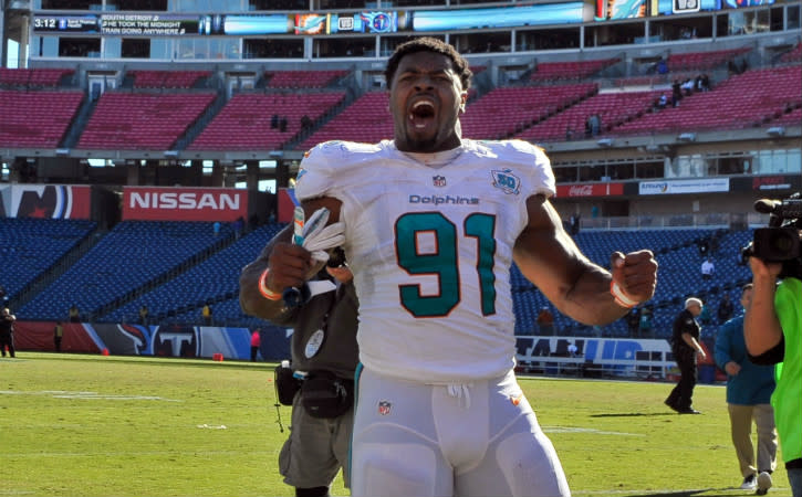 Oct 18, 2015; Nashville, TN, USA; Miami Dolphins defensive end Cameron Wake (91) celebrates as he leaves the field after his team defeated the Tennessee Titans during the second half at Nissan Stadium. Miami won 38-10. Mandatory Credit: Jim Brown-USA TODAY Sports