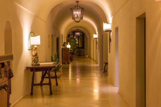 Gently lit stone corridors add to the spiritual feel at Monastero Santa Rosa (Monastero Santa Rosa)