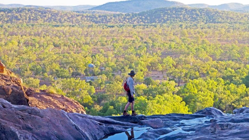 Woman walking across the top of the waterfall at Gunlom in Kakadu National Park. Image shot 2014. Exact date unknown.