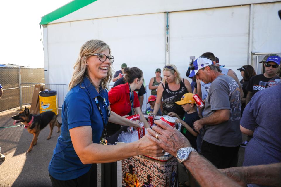 ISM Raceway President Julie Giese passes out drinks to campers on Nov. 7, 2019 at ISM Raceway in Avondale, AZ. (Brady Klain/The Republic)