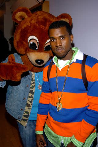 <p>Theo Wargo/WireImage</p> Kanye West poses for a photo with his "Dropout bear" mascot