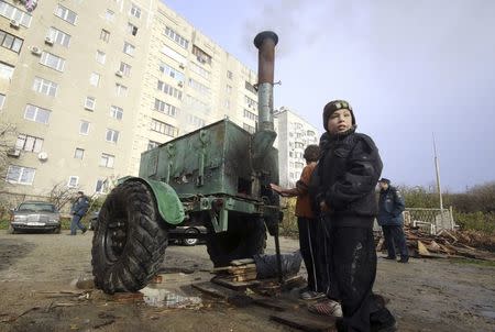 Children visit a mobile station, opened and operated by members of the Russian Emergencies Ministry to lend support to local residents due to power cuts, in the settlement of Gaspra, Crimea, in this November 27, 2015 file photo. REUTERS/Pavel Rebrov/Files