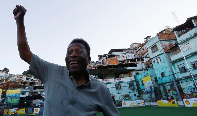 FILE PHOTO: Brazilian soccer legend Pele poses for the media during the inauguration of a refurbished soccer field at the Mineira slum in Rio de Janeiro