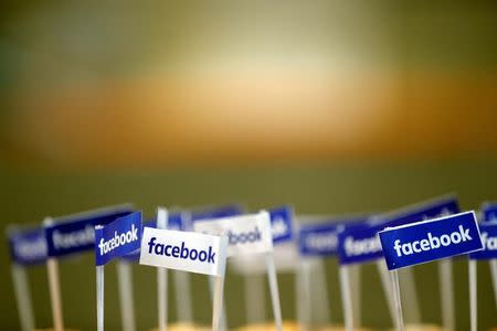 Miniature Facebook banners are seen on snacks prepared for the visit by Facebook's Chief Operating Officer in Paris, France, January 17, 2017. REUTERS/Philippe Wojazer/Files