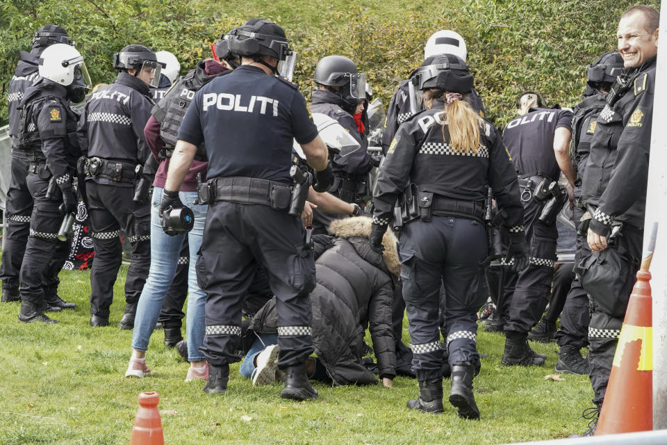 Police scuffle with demonstrators outside Iran's embassy in Oslo, Norway, Thursday, Sept. 29, 2022, as they protest the death of 22-year-old Mahsa Amini in custody in Iran after she was detained by the country’s morality police. Several people attempted to enter the Iranian Embassy in Oslo, police said Thursday, with scuffles breaking out and rocks being thrown at officers with authorities saying some 90 people had been detained. (Terje Pedersen/NTB Scanpix via AP)