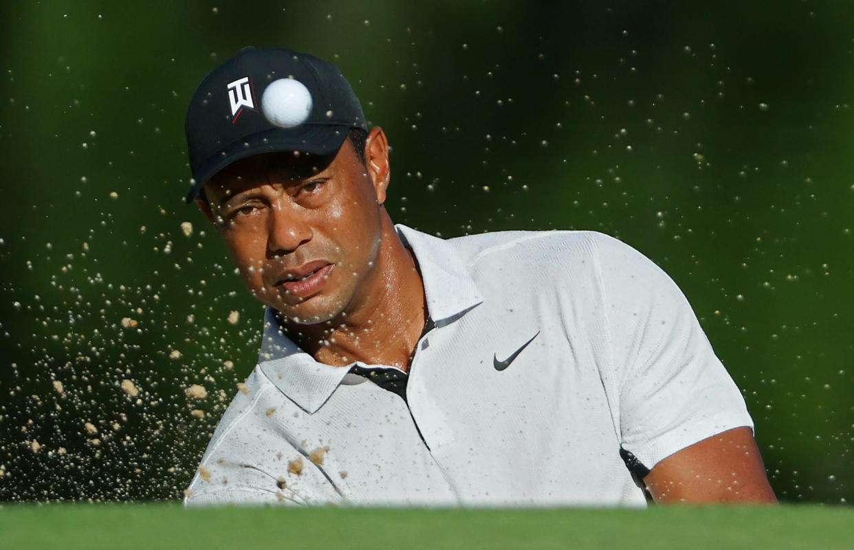 TULSA, OKLAHOMA - MAY 16: (EDITOR'S NOTE: Alternate crop) Tiger Woods of the United States plays a shot from a bunker during a practice round prior to the start of the 2022 PGA Championship at Southern Hills Country Club on May 16, 2022 in Tulsa, Oklahoma. (Photo by Andrew Redington/Getty Images)