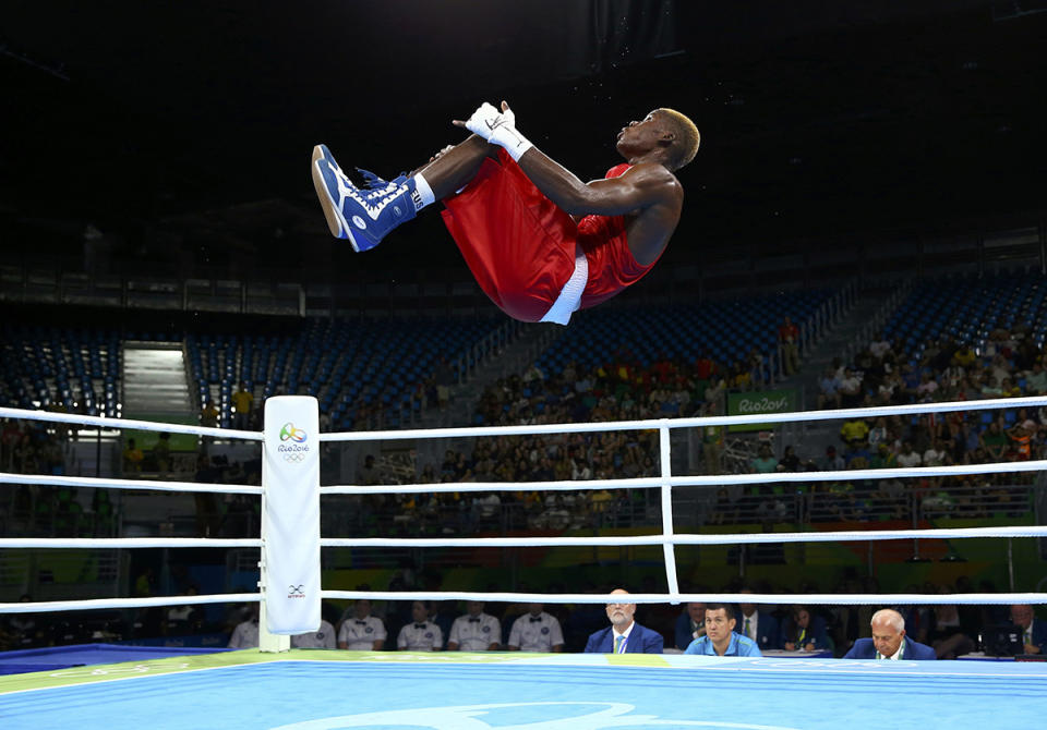 <p>Dieudonne Wilfred Seyi Ntsengue of Cameroon performs a somersault after winning his bout in men’s middle (75kg) boxing on August 9, 2016. (REUTERS/Peter Cziborra) </p>