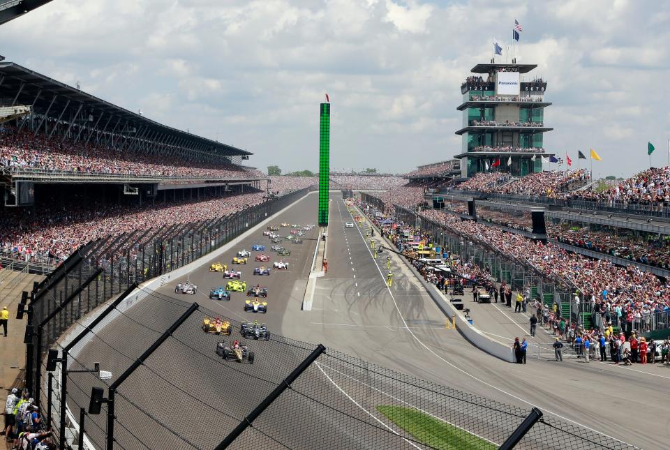 James Hinchcliffe leads the field into the first turn on the start of the 100th running of the Indianapolis 500 at Indianapolis Motor Speedway in Indianapolis.