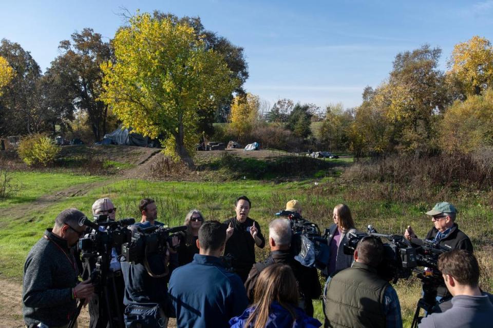 Sacramento County District Attorney Thien Ho speaks to the media about the environmental, health and safety issues caused by encampments along river levees during a tour with the River City Waterway Alliance at Steelhead Creek in Sacramento on Tuesday.