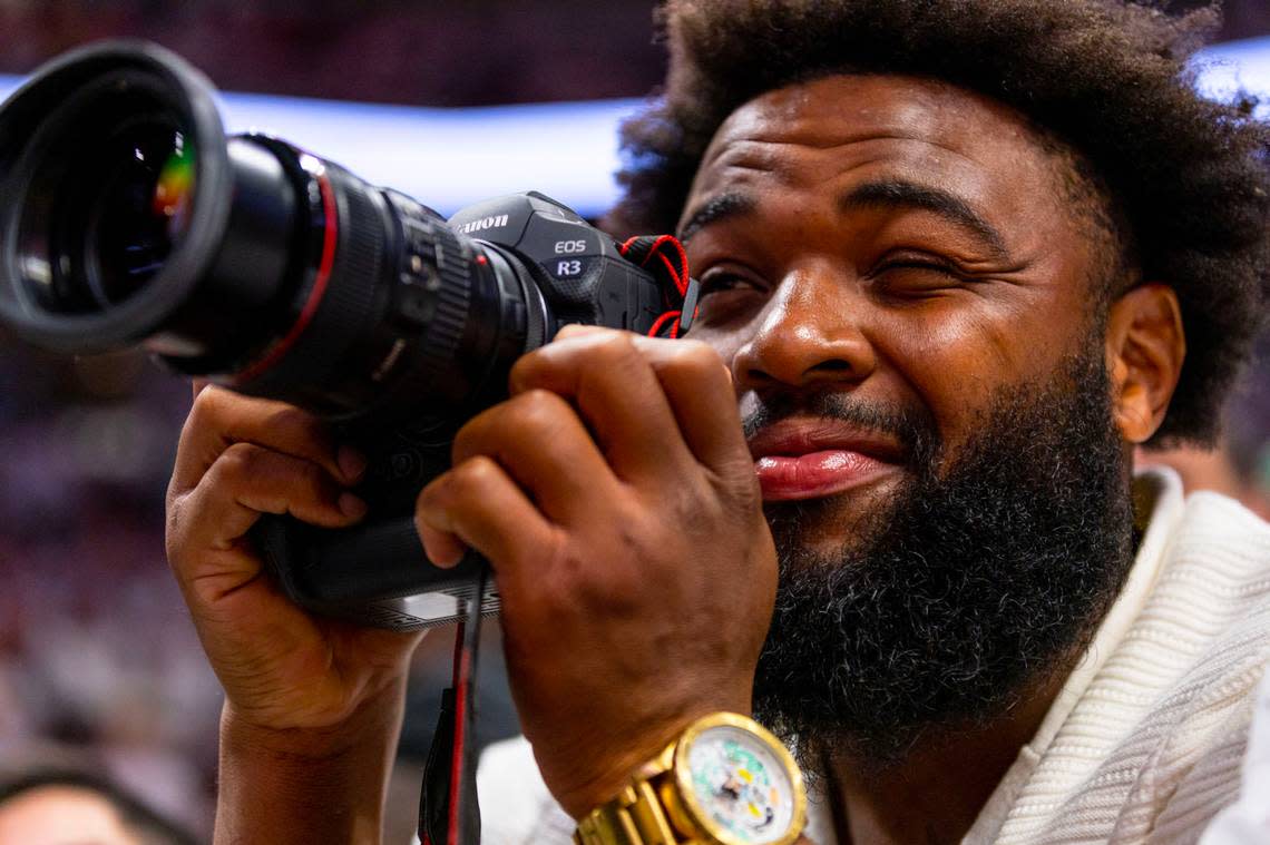 Miami Dolphins player Christian Wilkins uses a camera during the second half of Game 3 of the NBA Eastern Conference Finals series between the Miami Heat and Boston Celtics at Kaseya Center in Miami, Florida, on May 21, 2023. D.A. Varela/dvarela@miamiherald.com