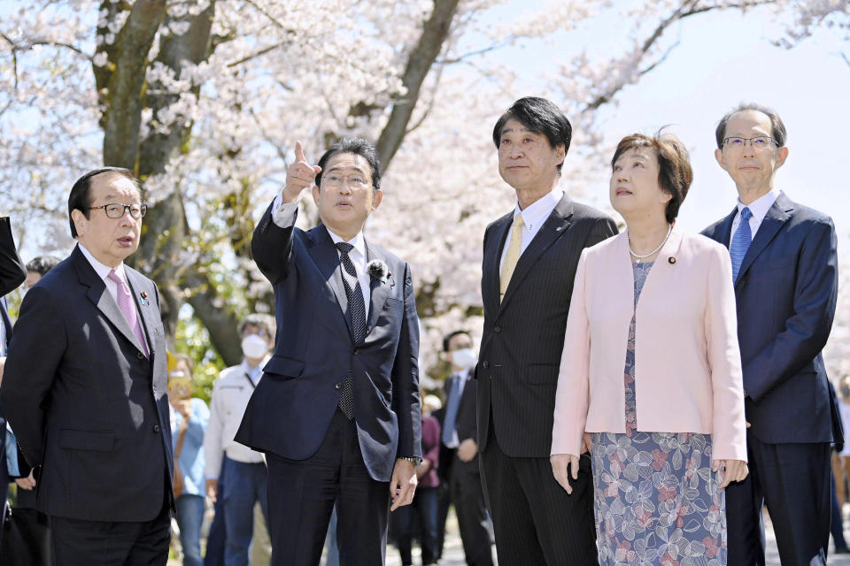 Japan's Prime Minister Fumio Kishida views cherry blossoms in Tomioka town, Fukushima prefecture, Japan Saturday, April 1, 2023. Evacuation orders were lifted in small sections of a Japanese town just southwest of the wrecked Fukushima nuclear power plant on Saturday, in time for the area’s popular cherry blossom season, and Kishida joined a ceremony to mark the reopening. (Kyodo News via AP)
