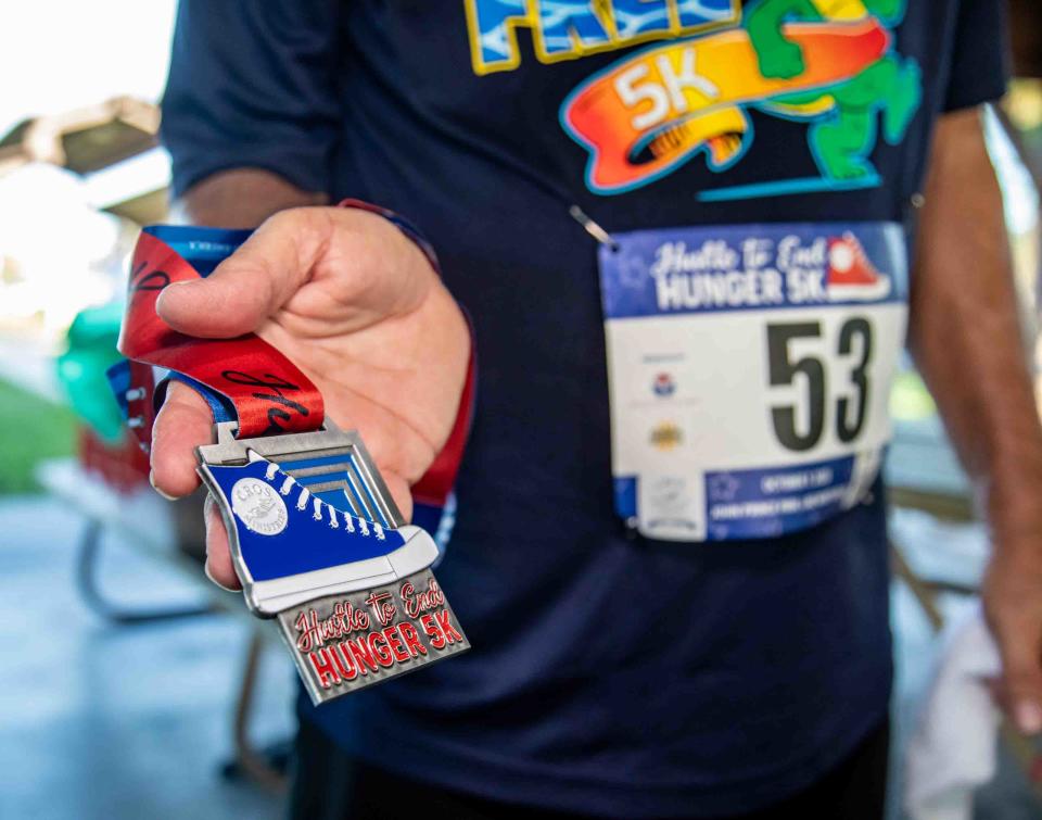 Pollack shows off his medal from the Oct. 7 race.