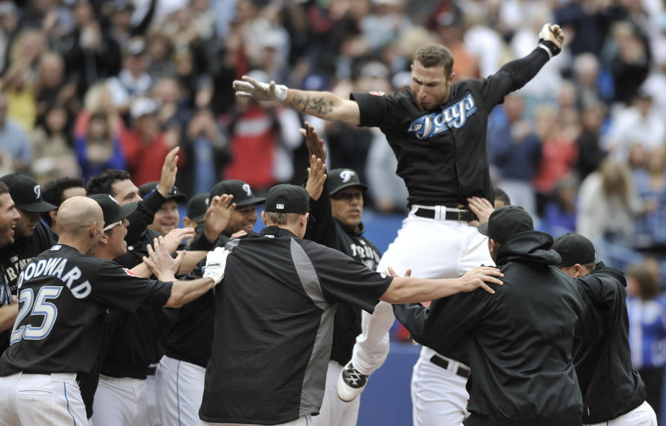 TORONTO, CANADA - SEPTEMBER 05: Brett Lawrie #13 of the Toronto Blue Jays celebrates his bottom of the 11th inning walk off home run with teammates during MLB game action against the Boston Red Sox September 5, 2011 at Rogers Centre in Toronto, Ontario, Canada. (Photo by Brad White/Getty Images)