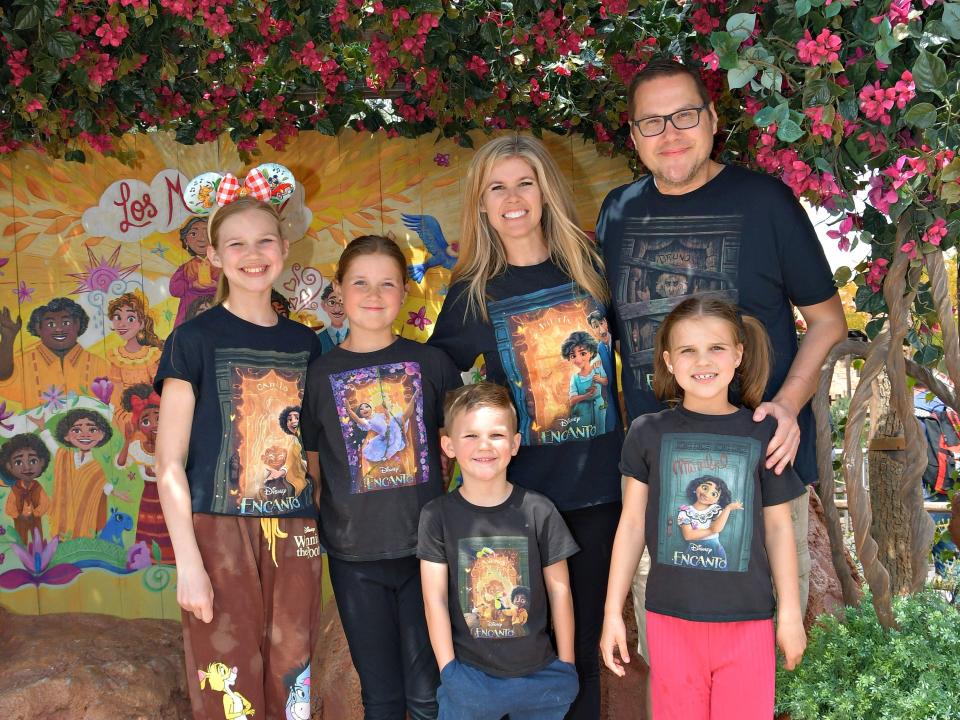 Author Daryl Austin and his family at Disneyland wearing Encanto shirts 