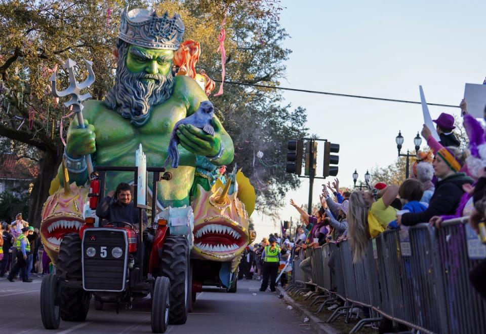 The Krewe of Proteus rolls on the Uptown route with the theme “Divine Tricksters” in New Orleans on Monday, Feb. 28, 2022 (AP)