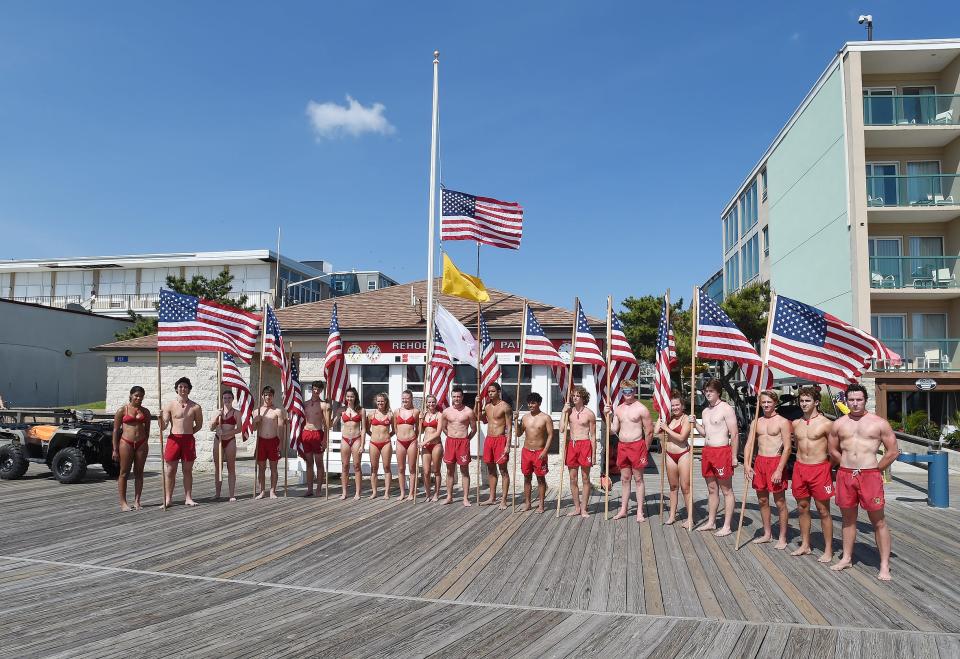 The Rehoboth Beach Patrol runs prepare to run with their Flags on the Beach to mark Memorial Day in Rehoboth Beach.