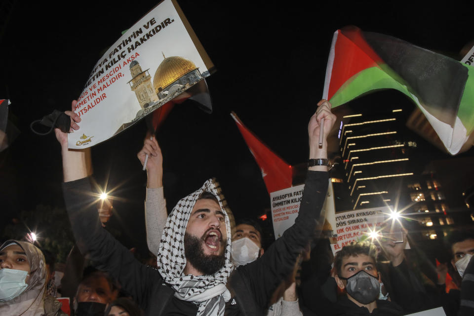 Protesters from IHH, a Turkish pro-Islamic organization chant anti-Israel slogans during a rally outside Israel's consulate in Istanbul, early Monday, May 10, 2021, in support of Palestinians in the latest round of violence in Jerusalem. Dozens of Palestinians were wounded in violent confrontations with police in Jerusalem overnight from Saturday to Sunday. On Friday, more than 200 Palestinians were wounded in clashes at the Al-Aqsa Mosque compound and elsewhere in Jerusalem, drawing condemnations from Israel's Arab allies and calls for calm from the United States, Europe and the United Nations. (AP Photo/Emrah Gurel)