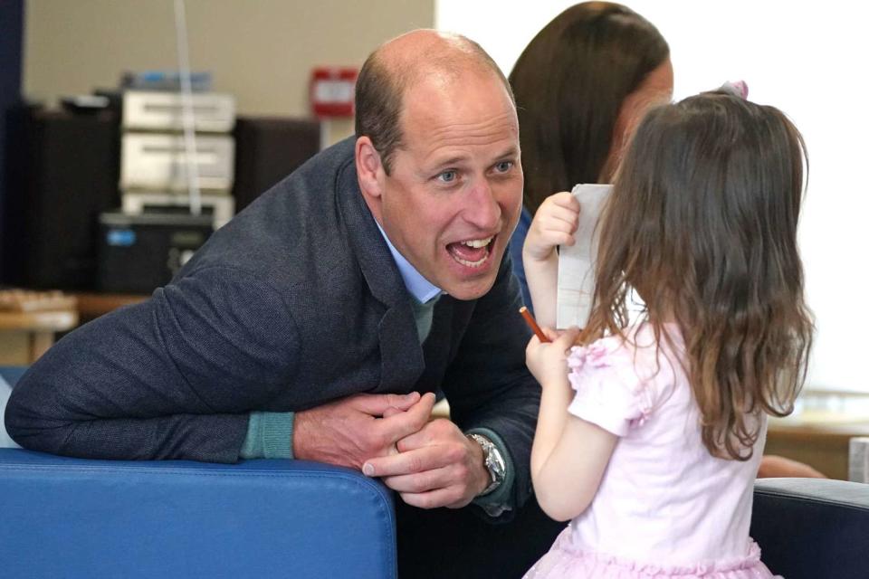 Prince William speaks to Olivia Wilson, two, during a visit to the Wheatley Group in Glasgow, to hear about the challenges of homelessness in Scotland