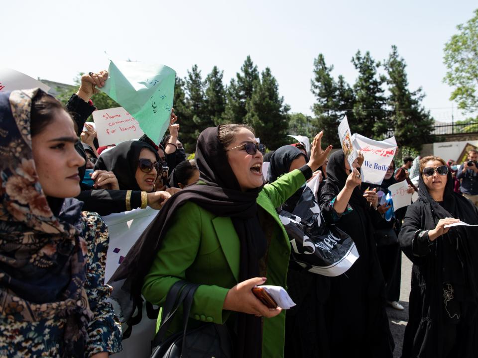 women protesting, holding banners on a street in Kabul, Afghanistan