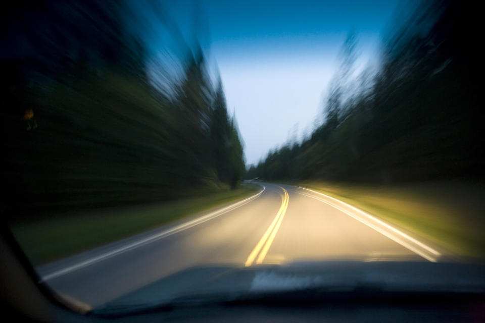 blurry photo of the road lit up with headlights