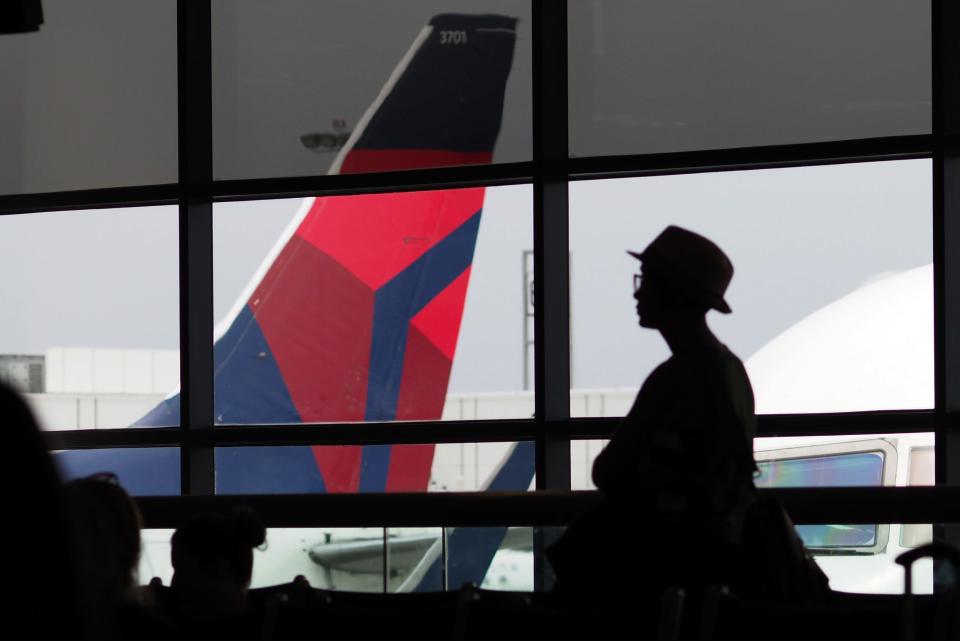 A passengers waits for a Delta Airlines flight in Terminal 5 at Los Angeles International Airport, May 4, 2017 in Los Angeles, California.