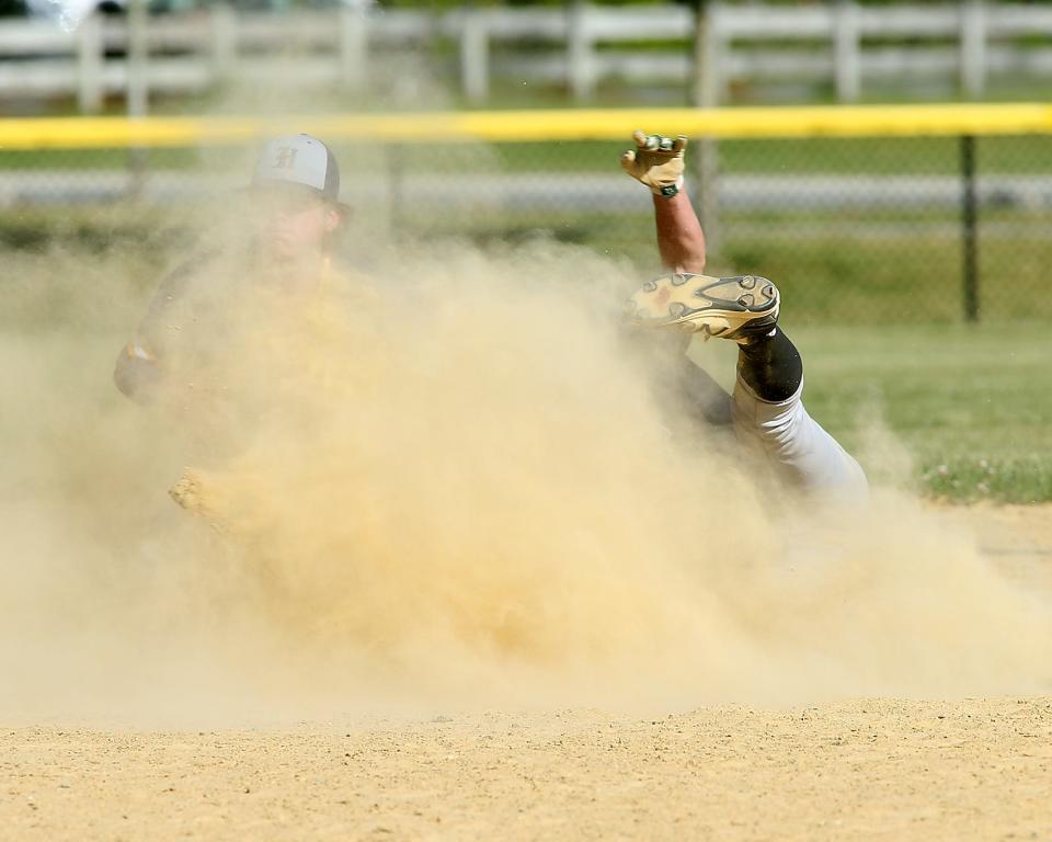 Hanover's Wesley Bryan applies the tag on Marshfield's Harry Cooley underneath a cloud of dust while getting caught stealing in the bottom of the fifth inning of their game against Marshfield at Marshfield High School on Thursday, May 26, 2022.