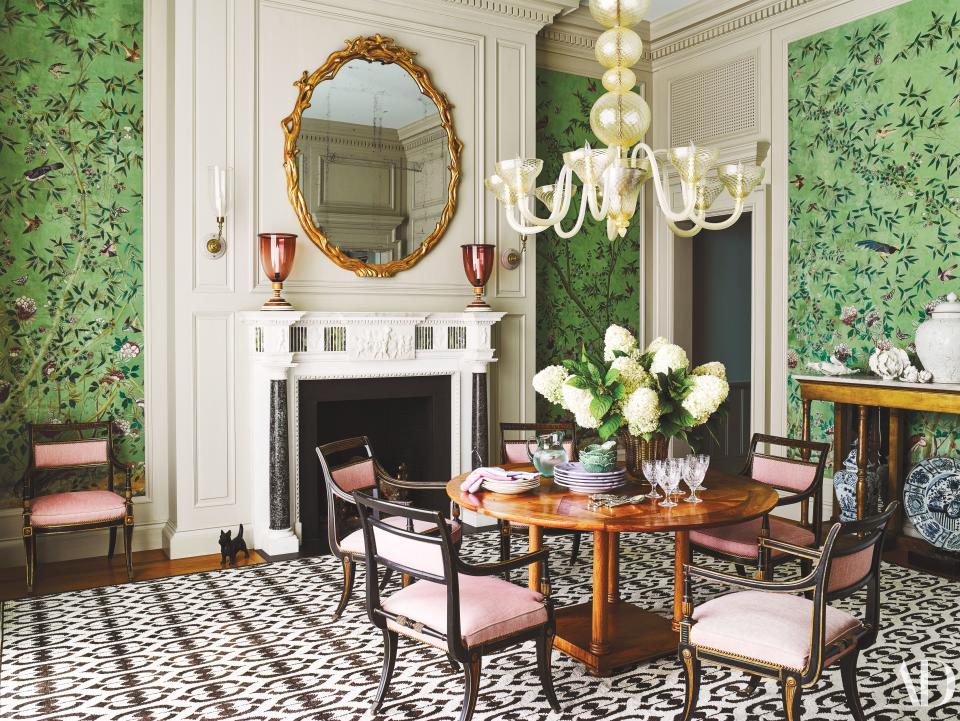 A 19th-century wallpaper covers the dining room. Murano chandelier; circa-1920 chairs in a Cowtan & Tout fabric.