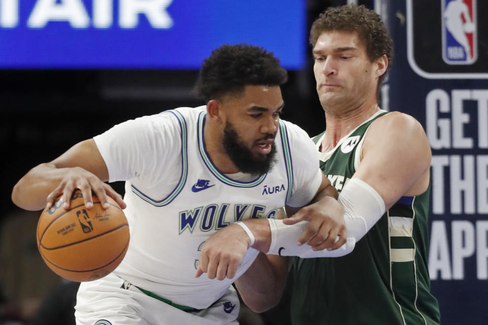 Minnesota Timberwolves forward Karl-Anthony Towns, left, works around Milwaukee Bucks center Brook Lopez during the first half of an NBA basketball game Friday, Feb. 23, 2024, in Minneapolis. (AP Photo/Bruce Kluckhohn)