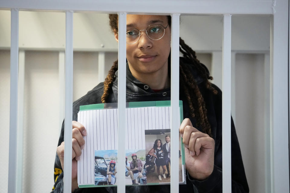 WNBA star and two-time Olympic gold medalist Brittney Griner holds images standing in a cage at a court room prior to a hearing, in Khimki just outside Moscow, Russia, Tuesday, July 26, 2022. American basketball star Brittney Griner has returned to a Russian courtroom for her drawn-out trial on drug charges that could bring her 10 years in prison if convicted. (AP Photo/Alexander Zemlianichenko, Pool)