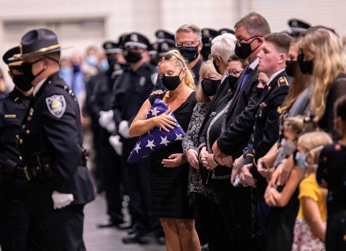 Jacob Hancher’s mom, Suzanne Williams, holds a flag that draped over her son’s casket. Hancher was killed in a shooting on Oct. 3 in Myrtle Beach and the community held a funeral for the fallen officer on Friday.