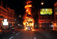 A double-decker bus engulfed in flames as vehicles and buildings were attacked by arsonists.