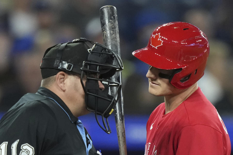 Toronto Blue Jays' Matt Chapman, right, disputes a strike call with the home plate umpire during eighth-inning baseball game action against the Baltimore Orioles in Toronto, Monday, July 31, 2023. (Nathan Denette/The Canadian Press via AP)