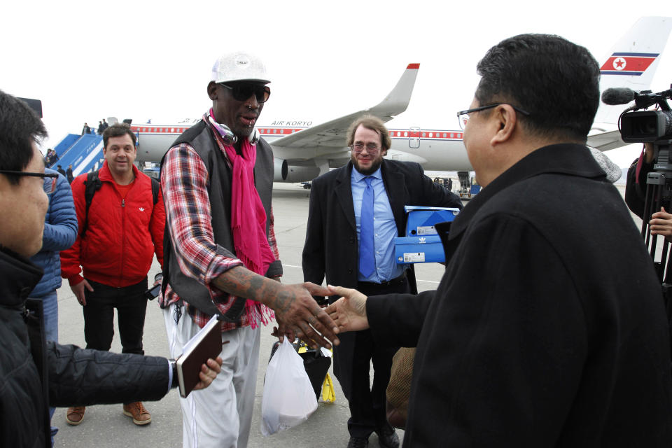 Former NBA basketball star Dennis Rodman shakes hands with North Korea's Sports Ministry Vice Minister Son Kwang Ho upon his arrival at the international airport in Pyongyang, North Korea, Monday, Jan. 6, 2014. Rodman took a team of former NBA players on a trip for an exhibition game on Kim Jong Un's birthday, Wednesday, Jan. 8. (AP Photo/Kim Kwang Hyon)