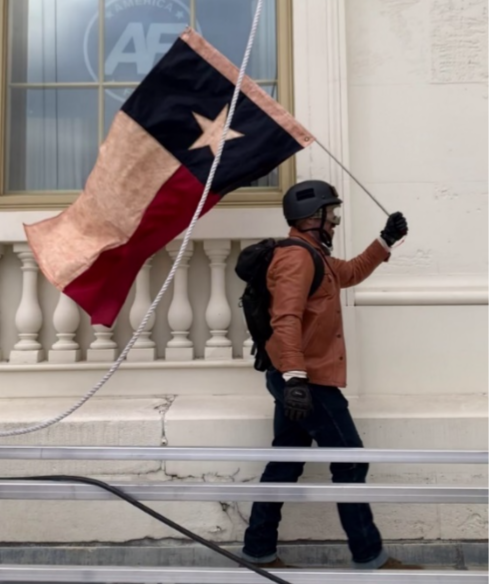 The FBI obtained photos of this man, who investigators say is 37-year-old Geoffrey Shough of Austin, carrying a Texas flag at the Jan. 6, 2021, Capitol insurrection.