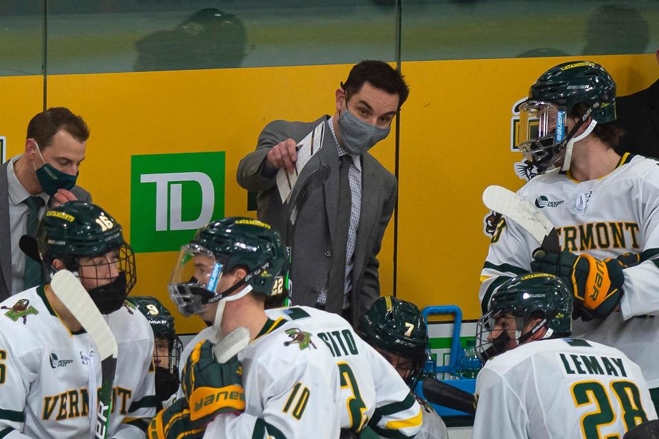 Todd Woodcroft, center, talks to the bench during a 2021 game.