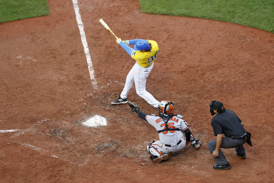 Boston Red Sox batter Triston Casas follows through on a three-run home run scoring Ceddanne Rafaela and Rafael Devers as Baltimore Orioles catcher Adley Rutschman (35) looks on during the sixth inning of a baseball game at Fenway Park, Sunday, Sept. 10, 2023, in Boston. (AP Photo/Mary Schwalm)