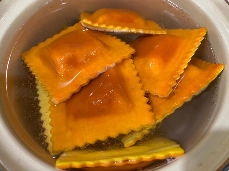 Orange and yellow two-tone raviolis in bowl