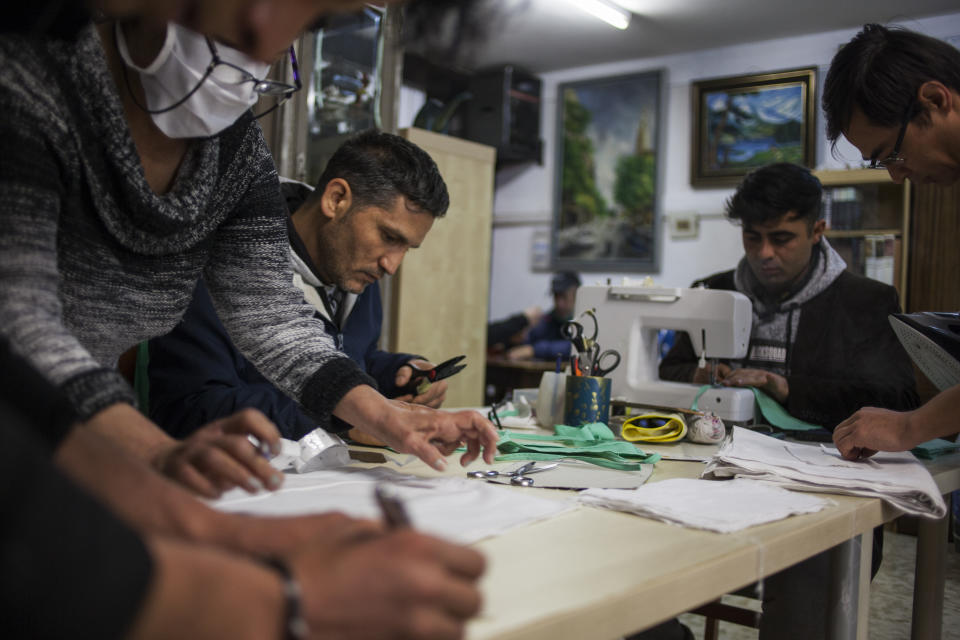 Homeless people staying at the House of Cadiz squat shelter for the homeless, manufacture face masks in Barcelona, on March,  2020. - About 25 homeless squatters staying are the former bar House of Cadiz, that was occupied in 2018 to be used as a shelter for the homeless, manufacture handmade face masks to be used against the novel coronavirus outbreak, during their auto-confinement at the squat. (José Colon for Yahoo News)