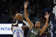 Oklahoma City Thunder guard Shai Gilgeous-Alexander (2) shoots as Minnesota Timberwolves center Rudy Gobert (27) defends him in the first quarter of an NBA basketball game Saturday, Dec. 3, 2022, in Minneapolis. (AP Photo/Bruce Kluckhohn)