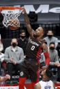 Portland Trail Blazers guard Damian Lillard dunks during the first half of the team's NBA basketball game against the Detroit Pistons in Portland, Ore., Saturday, April 10, 2021. (AP Photo/Steve Dykes)