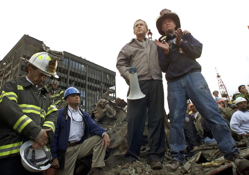 A September 14, 2001 file photo shows U.S. President George W. Bush talks to retired firefighter Bob Beckwith (R) from Ladder 117 at the scene of the World Trade Center disaster in New York. Al Qaeda leader Osama bin Laden was killed on Sunday in a firefight with U.S. forces in Pakistan and his body was recovered, President Barack Obama announced on Sunday. "Justice has been done," Obama said in a dramatic, late-night White House speech announcing the death of the elusive mastermind of the Sept. 11, 2001, attacks on the New York and Washington. REUTERS/Win McNamee/Files