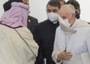 Pope Francis , right, arrives at an interreligious meeting near the archaeological area of the Sumerian city-state of Ur, 20 kilometers south-west of Nasiriyah, Iraq, Saturday, March 6, 2021. Ur is considered the traditional birthplace of Abraham, the prophet common to Muslims, Christians and Jews. Earlier today Francis met privately with the country's revered Shiite leader, Grand Ayatollah Ali al-Sistani. (AP Photo/Andrew Medichini)