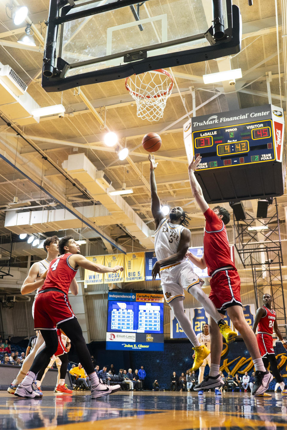 La Salle's Anwar Gill, center right, goes up for the shot as he gets past Dayton's Isaac Jack, right, during the second half of an NCAA college basketball game Tuesday, Jan. 23, 2024, in Philadelphia. Dayton won 66-54. (AP Photo/Chris Szagola)