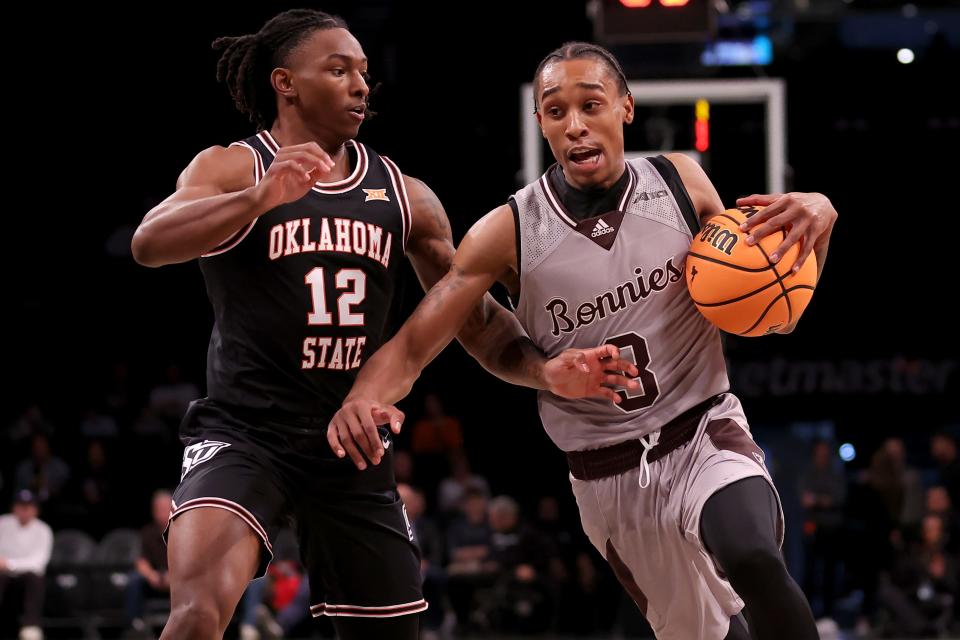 Nov 16, 2023; Brooklyn, New York, USA; St. Bonaventure Bonnies guard Mika Adams-Woods (3) drives to the basket against Oklahoma State Cowboys guard Javon Small (12) during the first half at Barclays Center. Mandatory Credit: Brad Penner-USA TODAY Sports