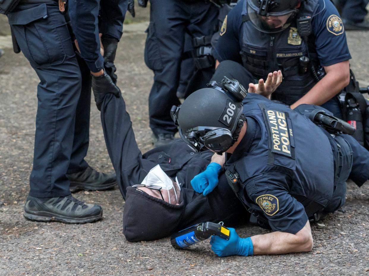 Portland Police detain a protester who re-occupied the Portland State University Library building with others after it had been cleared and several protesters were detained earlier in the day, during the ongoing conflict between Israel and the Palestinian Islamist group Hamas, in Portland, Oregon, U.S., May 2, 2024 (REUTERS)