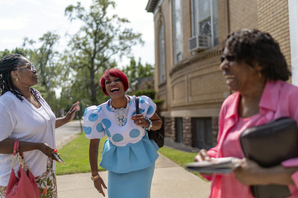 Pastoral assistant, Karen Anderson Hardaway, center, talks with Tameka Felts, left, and Marie Holloman following a service at Trinity Baptist Church Sunday, Aug. 20, 2023, in Niagara Falls, N.Y. Anderson Hardaway says she understands how others seeking to preserve sanctuary fervently disagree. In a country where the average day sees more than 130 people killed with a gun, will the right to worship in peace be insulated from violence with one or without one? “There is no right answer,” she says. (AP Photo/David Goldman)